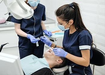 UB Dental Hygiene student with a patient